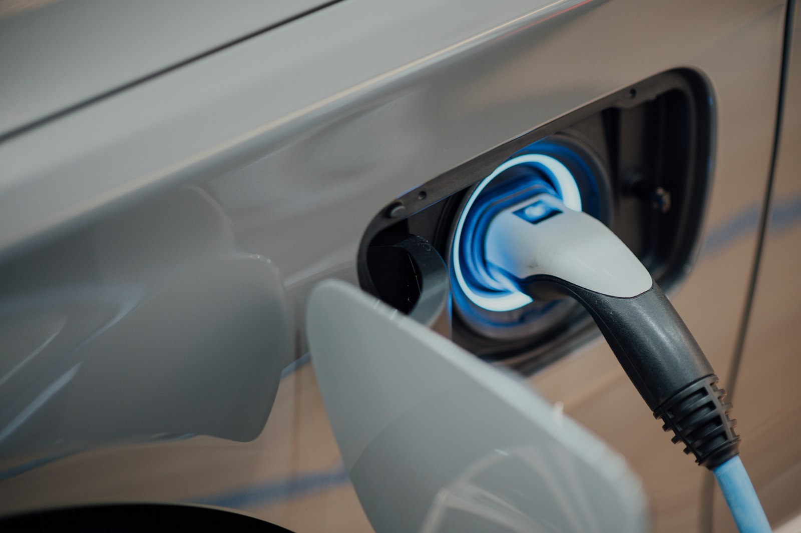 Electric vehicle charging plug connected to a car