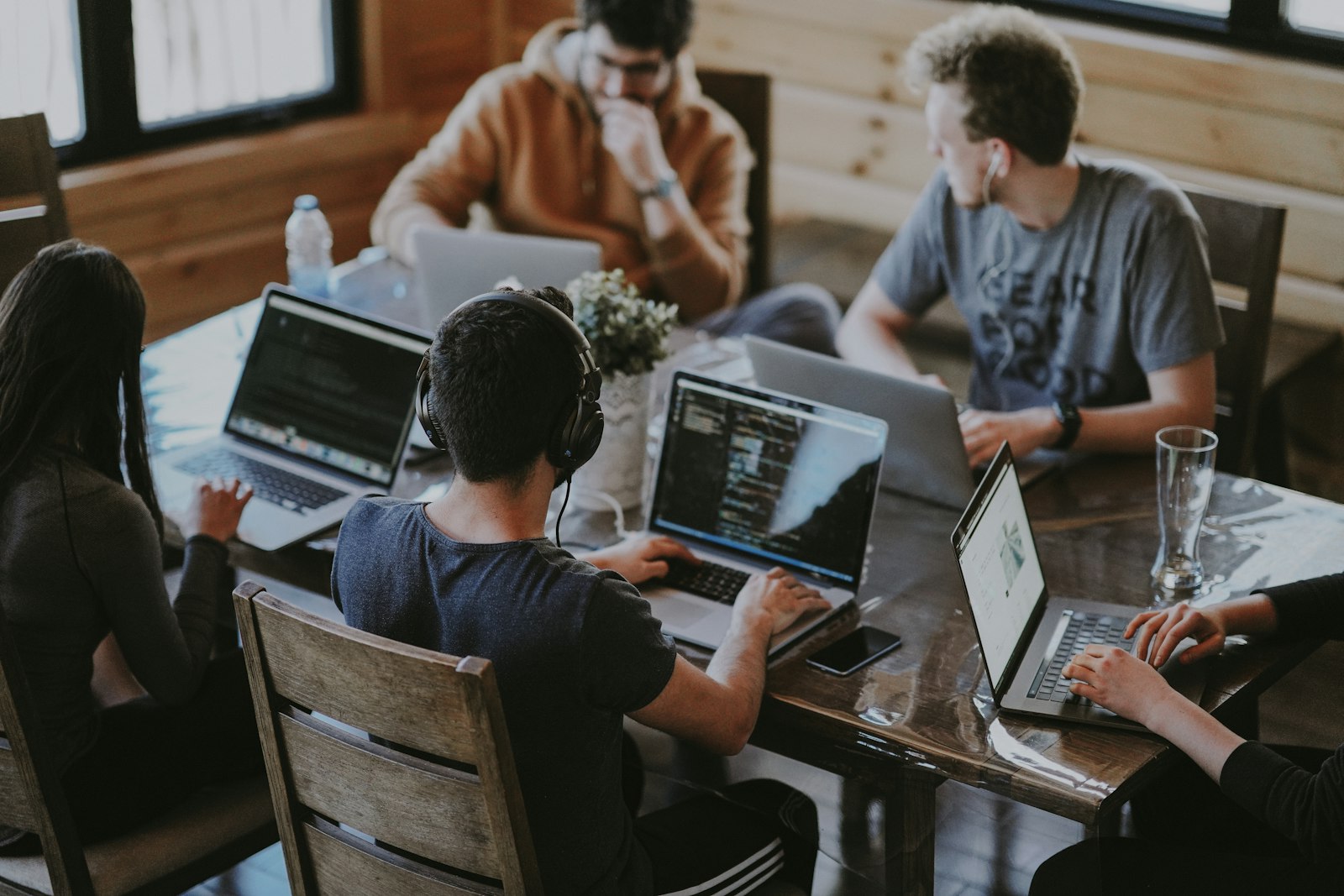 Startup team collaborating around laptops at a shared table